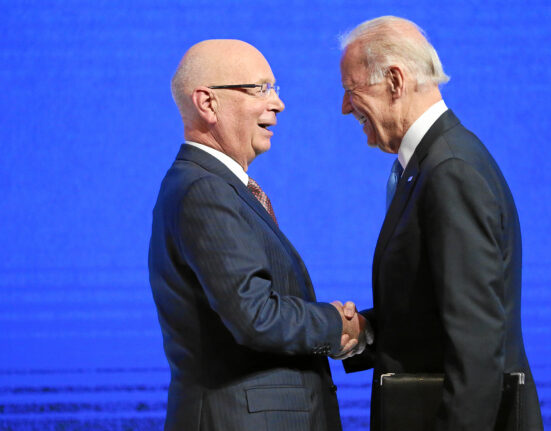 El presidente ejecutivo del Foro Económico Mundial, Klaus Schwab, estrecha la mano del presidente de EEUU, Joe Biden.